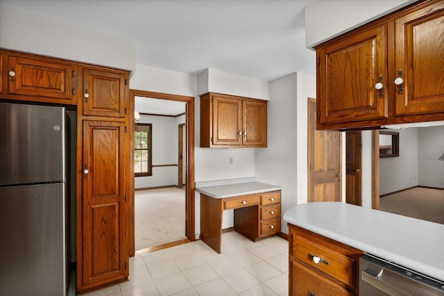 22 Cedar Gate Cir, Sugar Grove, IL 60554 - kitchen featuring stainless steel appliances, light countertops, brown cabinets, baseboards, and light colored carpet