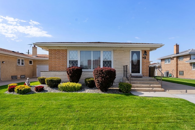 8557 W Winona St, Chicago, IL 60656 - view of front facade with a front yard and brick siding