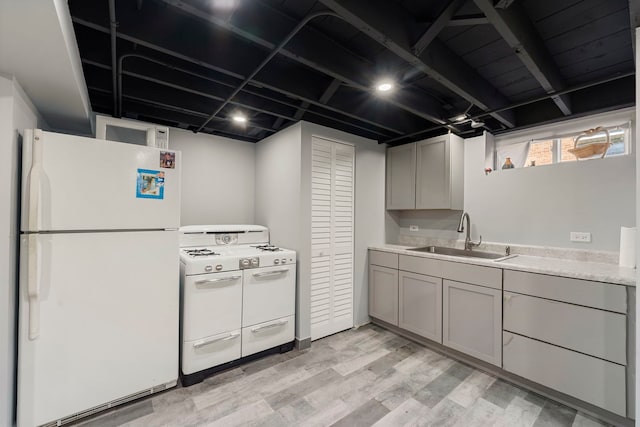8557 W Winona St, Chicago, IL 60656 - kitchen with white appliances, a sink, light wood-type flooring, light countertops, and gray cabinets