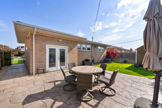 8557 W Winona St, Chicago, IL 60656 - view of patio featuring french doors, outdoor dining space, central AC unit, and a gate