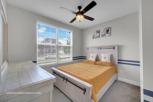 bedroom with baseboards, a ceiling fan, and light carpet