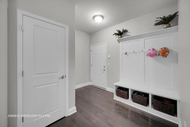 mudroom featuring dark wood-type flooring and baseboards
