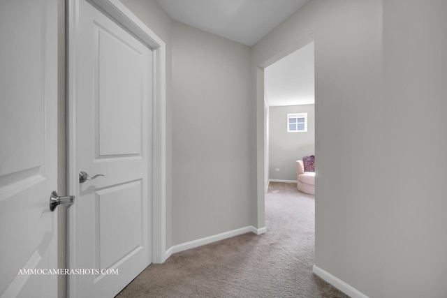 hallway with carpet and baseboards