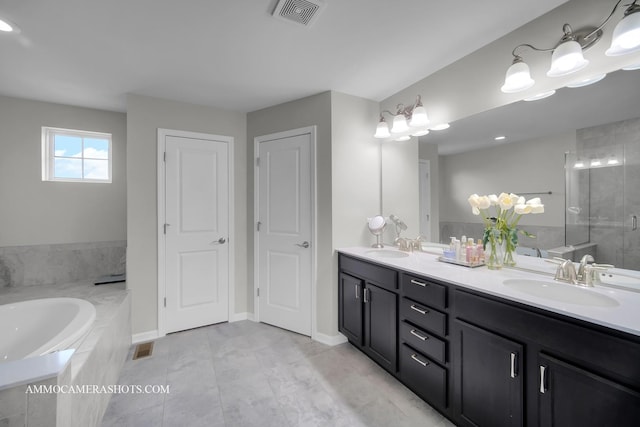 bathroom featuring a shower stall, a bath, double vanity, tile patterned floors, and baseboards