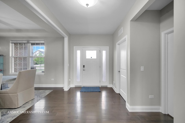 foyer entrance with baseboards and dark wood-style floors