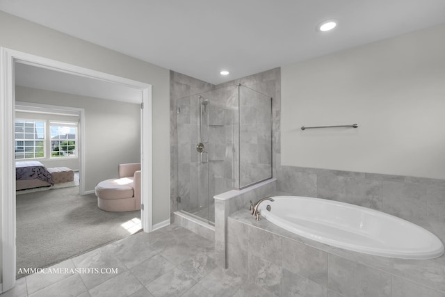 bathroom with a garden tub, a shower stall, ensuite bath, recessed lighting, and baseboards