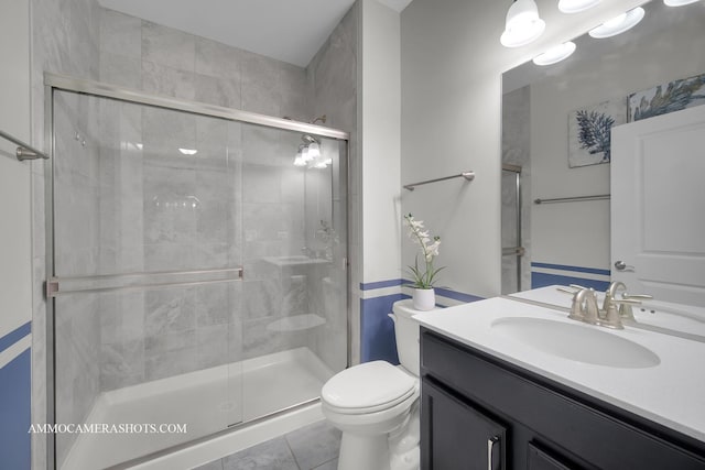 full bathroom featuring a shower stall, toilet, and vanity