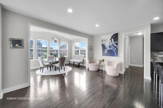 dining space featuring baseboards, dark wood-type flooring, a chandelier, and recessed lighting