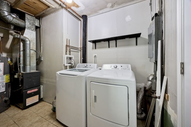 laundry area with washing machine and clothes dryer, light tile patterned floors, heating unit, and water heater