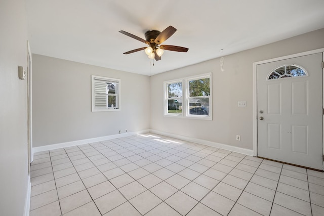 entryway featuring ceiling fan, baseboards, and light tile patterned floors
