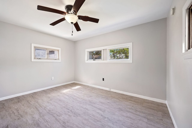 spare room with ceiling fan, baseboards, and wood finished floors