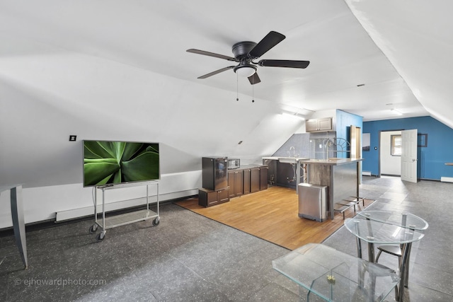 bonus room featuring a ceiling fan, vaulted ceiling, a sink, and baseboards