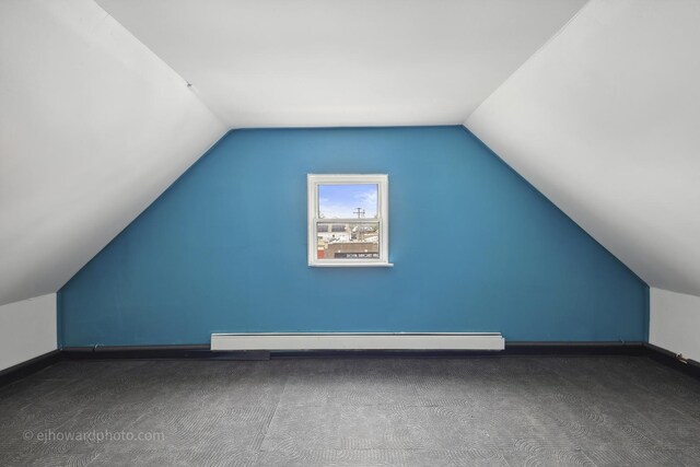 bonus room featuring carpet floors, lofted ceiling, baseboards, and a baseboard radiator