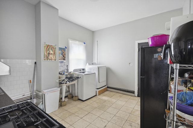 kitchen with separate washer and dryer, freestanding refrigerator, and light tile patterned floors