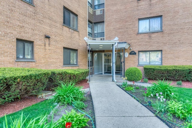 property entrance featuring brick siding