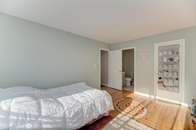 bedroom featuring wood finished floors and baseboards