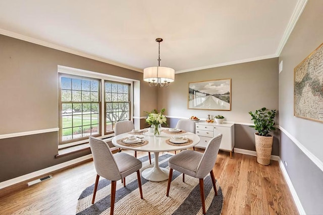 705 Skye Ln, Inverness, IL 60010 - dining area with a chandelier, light wood-style flooring, ornamental molding, and baseboards