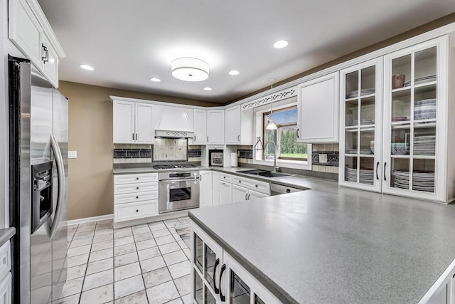 705 Skye Ln, Inverness, IL 60010 - kitchen with appliances with stainless steel finishes, a sink, tasteful backsplash, white cabinetry, and premium range hood