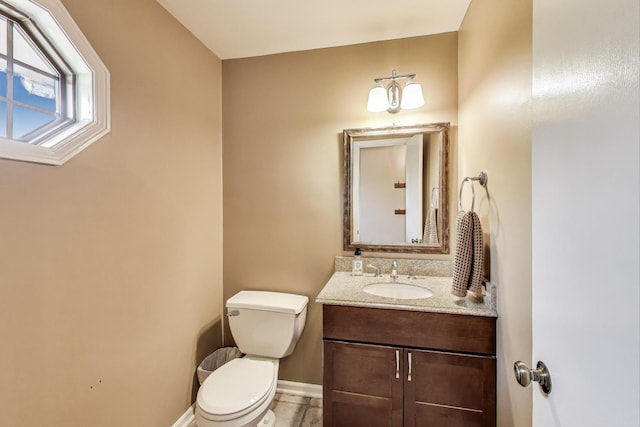 705 Skye Ln, Inverness, IL 60010 - half bathroom featuring toilet, vanity, and baseboards