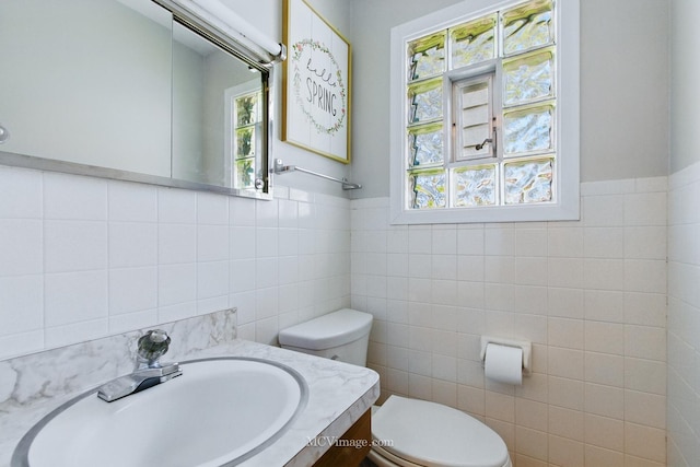19535 Midland Ave, Mokena, IL 60448 - half bathroom with tile walls, toilet, plenty of natural light, vanity, and wainscoting