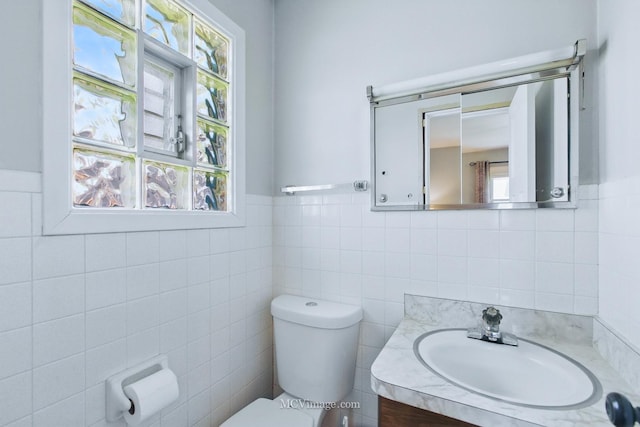 19535 Midland Ave, Mokena, IL 60448 - half bathroom with tile walls, toilet, vanity, and a wainscoted wall