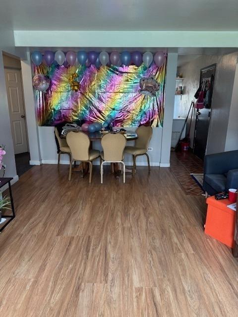 dining area with wood finished floors and baseboards