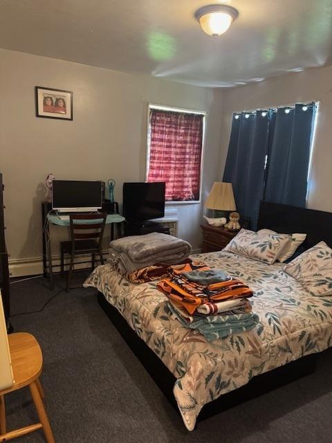 bedroom featuring carpet flooring and an office area