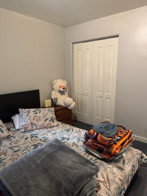 bedroom featuring a closet and baseboards