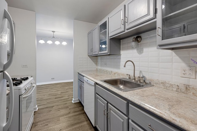 898 Wellington Ave Unit 218, Elk Grove Village, IL 60007 - kitchen with gray cabinetry, white appliances, a sink, dark wood-type flooring, and backsplash