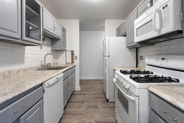 898 Wellington Ave Unit 218, Elk Grove Village, IL 60007 - kitchen with white appliances, a sink, gray cabinetry, wood finished floors, and backsplash