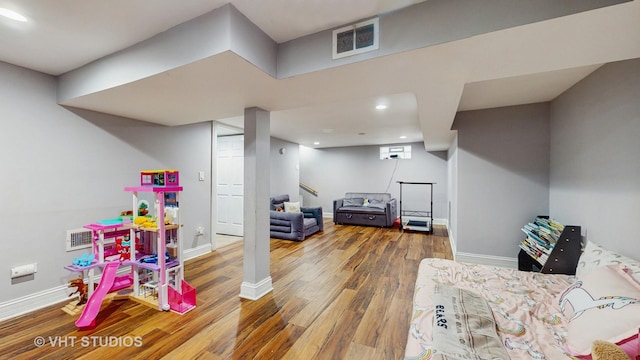 3033 Dora St, Franklin Park, IL 60131 - game room with wood finished floors, baseboards, recessed lighting, and a wall unit AC