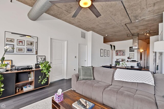 living area with a ceiling fan and wood finished floors