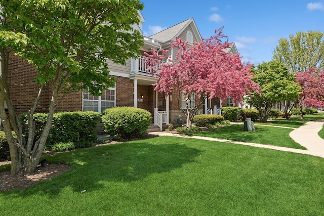 1892 Keystone Pl, Schaumburg, IL 60193 - obstructed view of property featuring a balcony, a front lawn, brick siding, and a porch