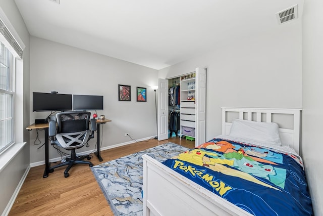 1892 Keystone Pl, Schaumburg, IL 60193 - bedroom with light wood finished floors, multiple windows, baseboards, and a closet