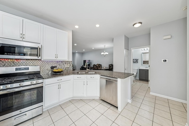 1892 Keystone Pl, Schaumburg, IL 60193 - kitchen with appliances with stainless steel finishes, a sink, white cabinets, tasteful backsplash, and a chandelier
