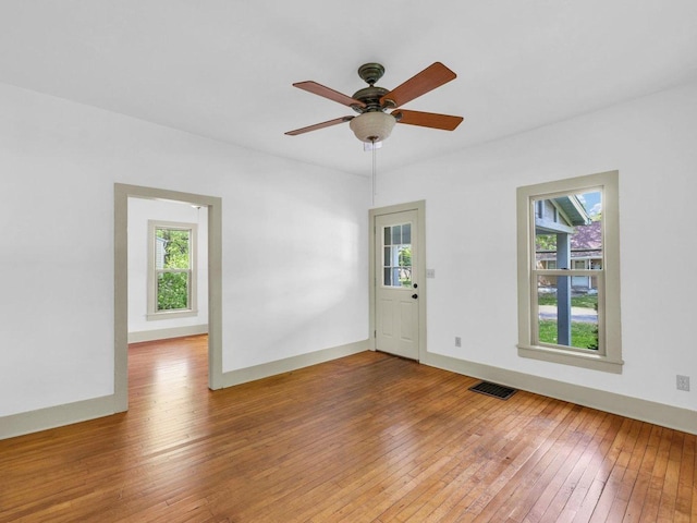 413 E Lincoln St, Monticello, IL 61856 - empty room featuring plenty of natural light, hardwood / wood-style flooring, and ceiling fan