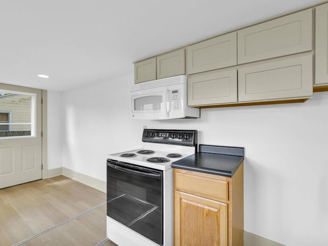 413 E Lincoln St, Monticello, IL 61856 - kitchen with range with electric stovetop, white microwave, light wood finished floors, baseboards, and recessed lighting