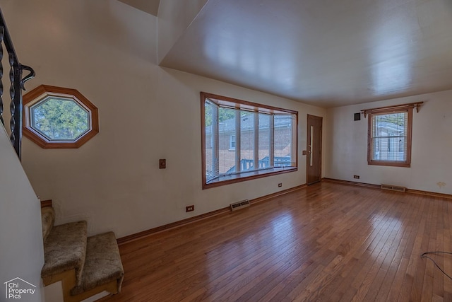 3525 N Ottawa Ave, Chicago, IL 60634 - unfurnished living room with hardwood / wood-style flooring, healthy amount of natural light, stairway, and baseboards