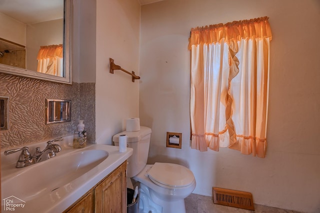 3525 N Ottawa Ave, Chicago, IL 60634 - bathroom with toilet, tasteful backsplash, and vanity