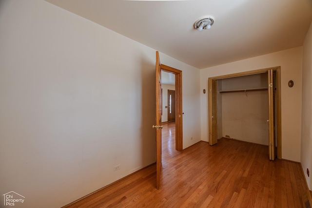 3525 N Ottawa Ave, Chicago, IL 60634 - unfurnished bedroom featuring light wood-type flooring and a closet