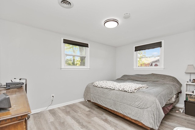 bedroom with wood finished floors and baseboards