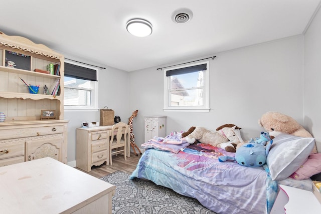 bedroom with light wood-style floors and baseboards