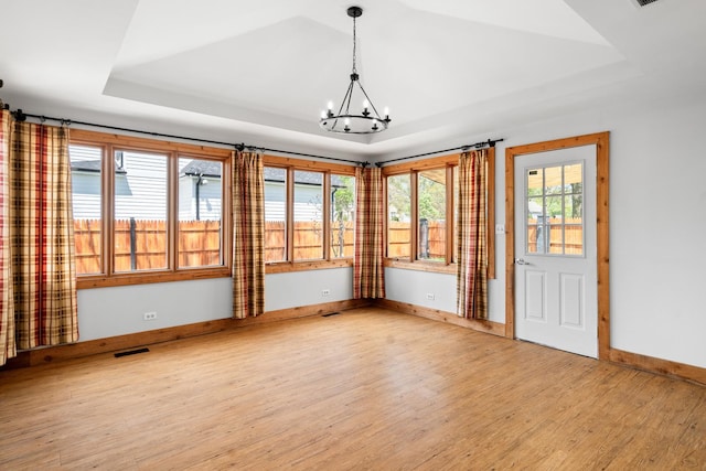unfurnished sunroom featuring a chandelier