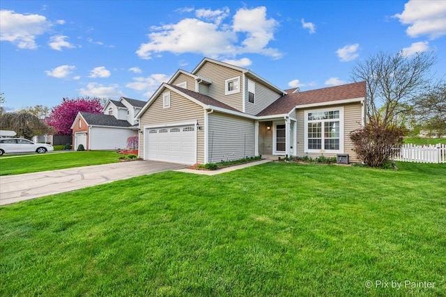 traditional-style home featuring an attached garage and driveway