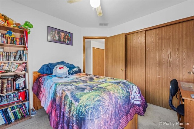 bedroom with carpet, ceiling fan, and a closet