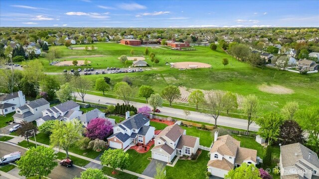 aerial view of residential area featuring a golf club