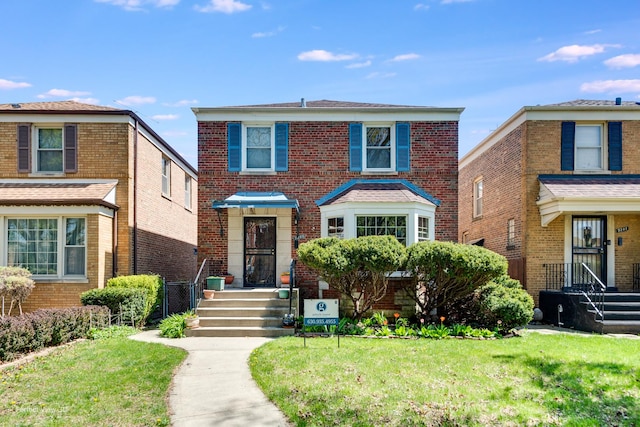 9245 S Justine St, Chicago, IL 60620 - view of front of property with a front yard and brick siding