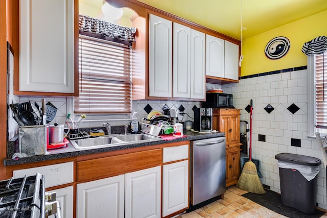 9245 S Justine St, Chicago, IL 60620 - kitchen with stainless steel dishwasher, a sink, black microwave, white cabinetry, and dark countertops