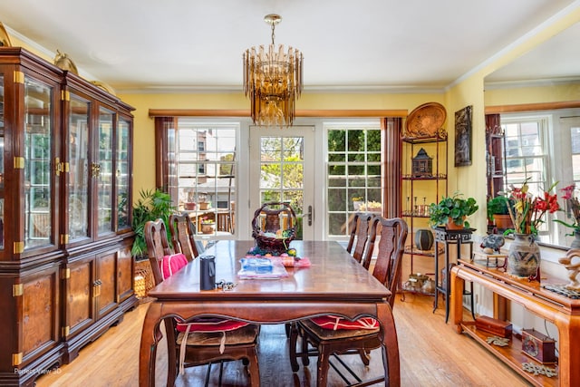 9245 S Justine St, Chicago, IL 60620 - dining space with a chandelier, light wood-style flooring, plenty of natural light, and ornamental molding