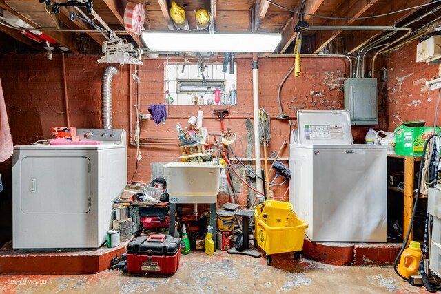 9245 S Justine St, Chicago, IL 60620 - basement featuring washer and clothes dryer, electric panel, and a sink